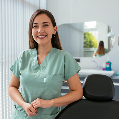 Female dental assistant standing in treatment room